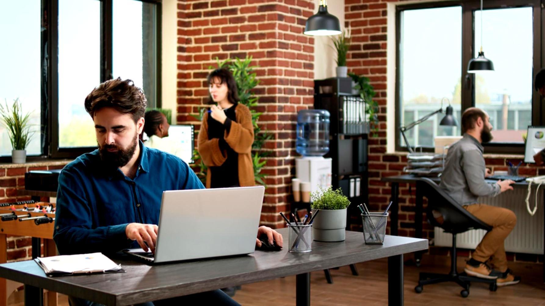 Students analyzing financial charts and market data on multiple computer screens